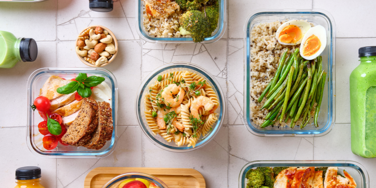 variety of healthy food in plastic containers on a table.