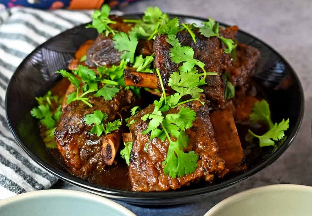 Paleo korean short ribs garnished with cilantro served on a plate