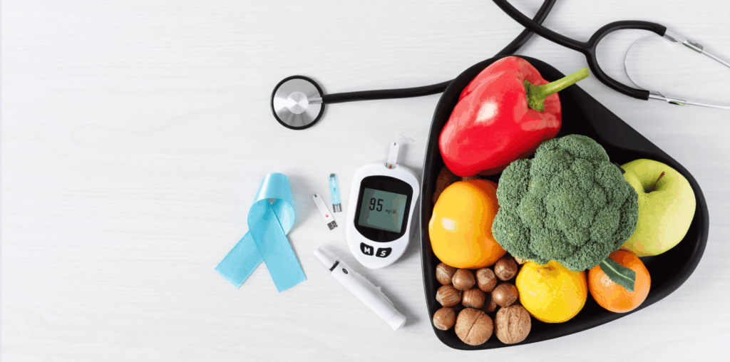 A stethoscope, fruits and vegetables, and a thermometer on a table.