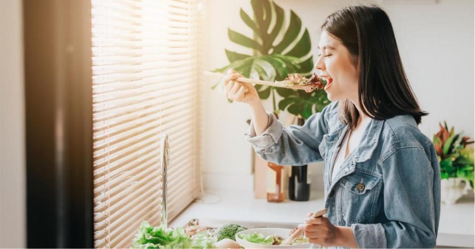 Woman enjoying a nutritious meal to boost her diet and mental well-being.