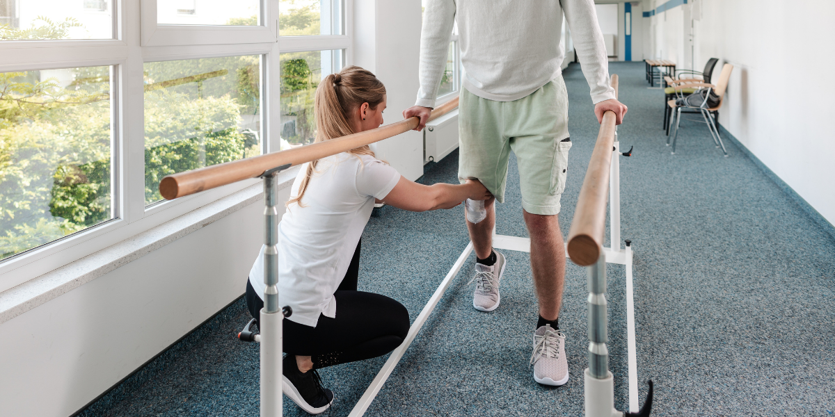 Physical therapist assisting an injured athlete in a recovery session.
