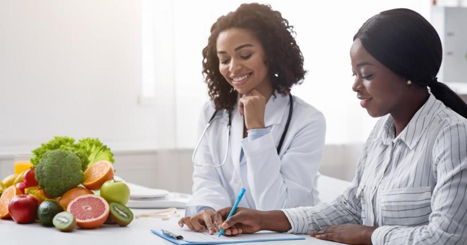 Woman consulting with functional nutritionist for healthy diet plan.