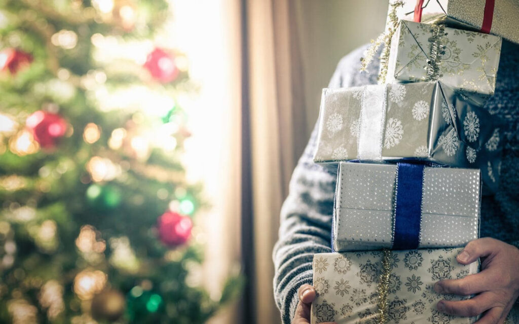 Man holding pile presents xxlarge orig